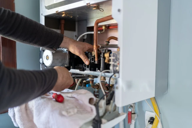 Gas plumber checking for gas leaks at a rental property